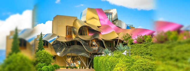 Trip Barcelona Reisetipps - Marqués de Riscal Design Hotel, Bilbao, Elciego, Spanien. Fantastisch galaktisch, unverkennbar ein Werk von Frank O. Gehry. Inmitten idyllischer Weinberge in der Rioja Region des Baskenlandes, bezaubert das schimmernde Bauobjekt mit einer Struktur bunter, edel glänzender verflochtener Metallbänder. Glanz im Baskenland - Es muss etwas ganz Besonderes sein. Emotional, zukunftsweisend, einzigartig. Denn in dieser Region, etwa 133 km südlich von Bilbao, sind Weingüter normalerweise nicht für die Öffentlichkeit zugänglich.